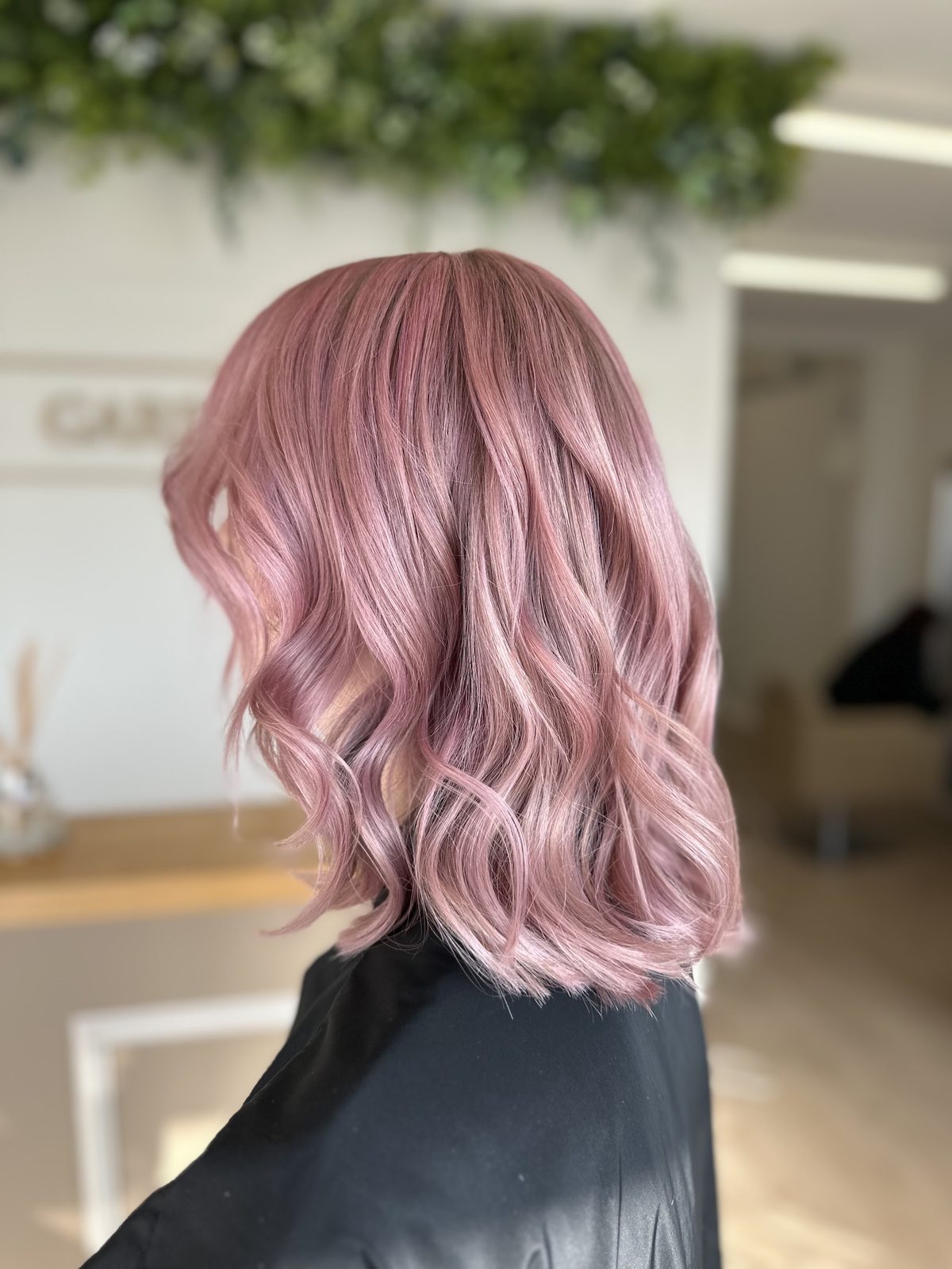 Pastel pink waves to the shoulder, seen from the side