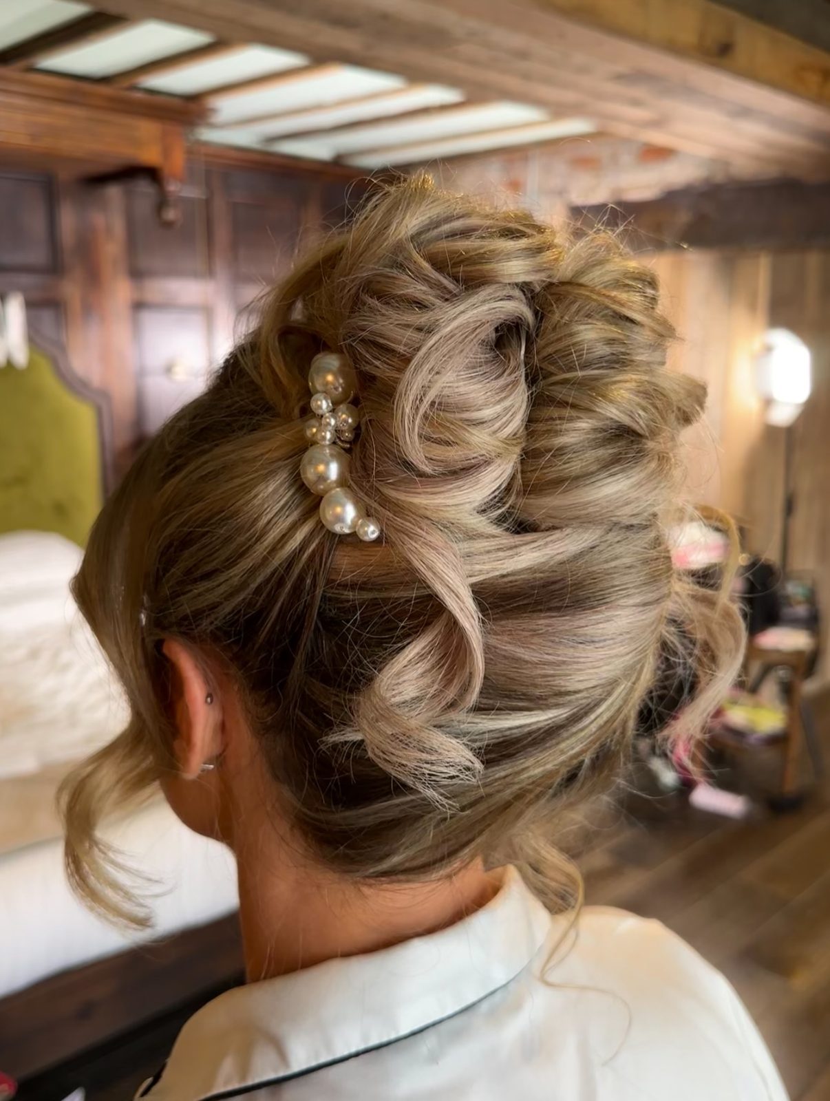 A bride's French twist finished with pearl clips