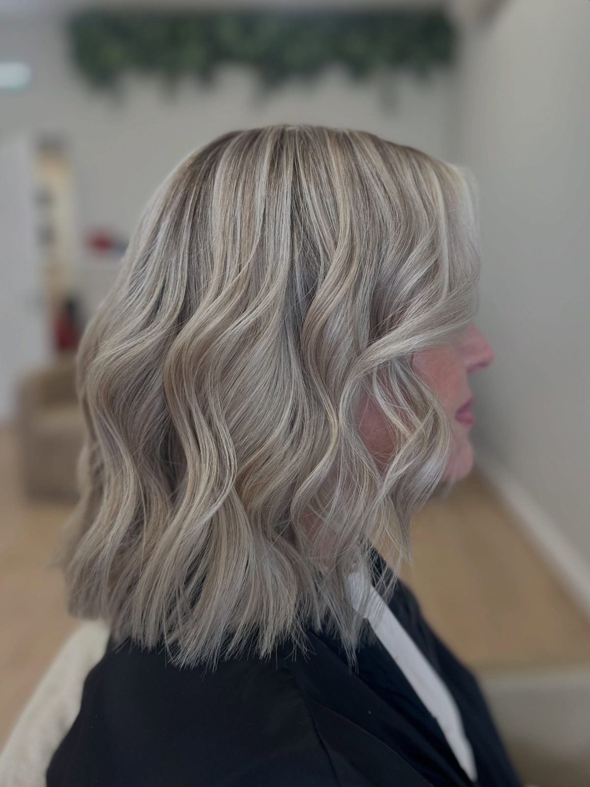 Ash blonde wavy bob with lowlights, side profile